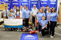 4-H Robotics team holding a check for $1,500.