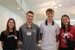 Four scholarship recipients standing together and smiling